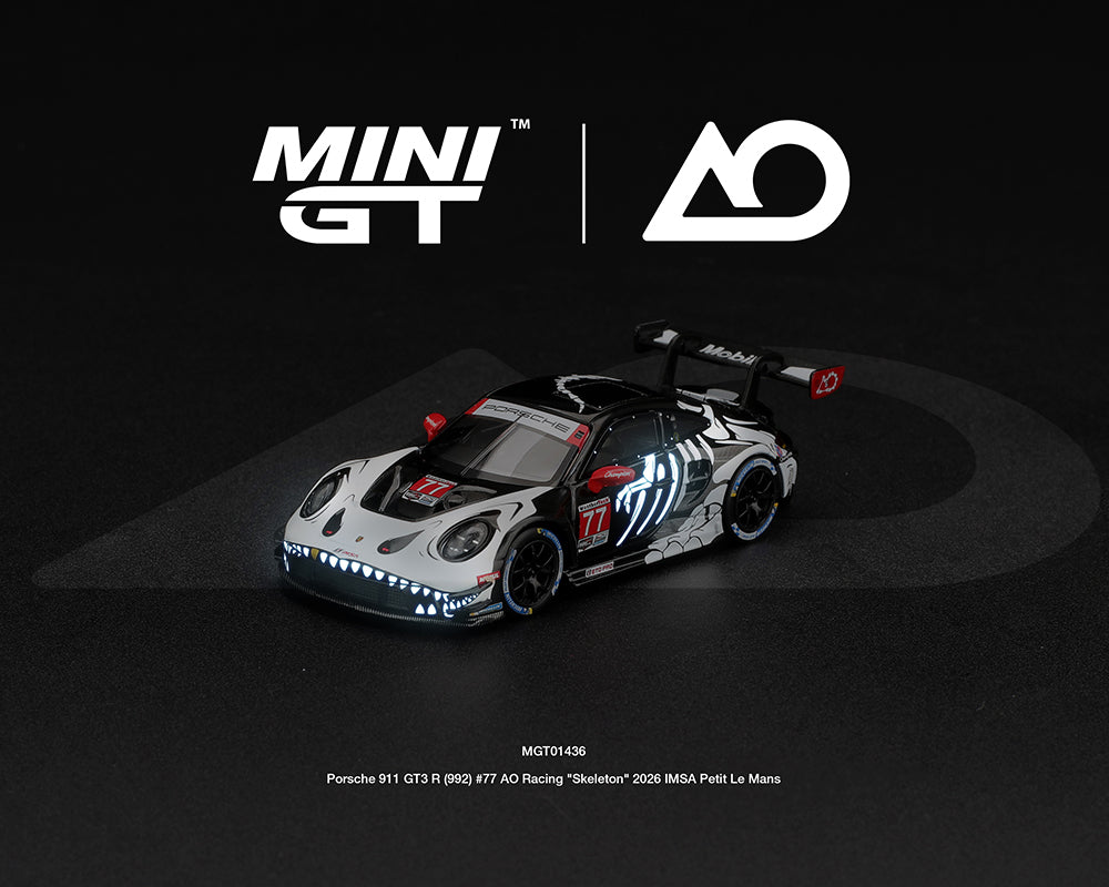 [PRE-ORDER] Estimated arrival April 2027| Mini GT 1:64 Porsche 911 GT3 R (992) #77 AO Racing “Skeleton Rexy” 2026 IMSA Petit Le Mans – (Glow in the Dark) – Limited Edition