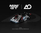 [PRE-ORDER] Estimated arrival April 2027| Mini GT 1:64 Porsche 911 GT3 R (992) #77 AO Racing “Skeleton Rexy” 2026 IMSA Petit Le Mans – (Glow in the Dark) – Limited Edition